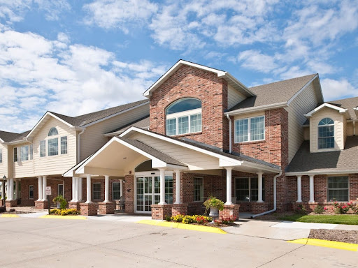 A welcoming exterior of a brick building with a sunny sky overhead.
