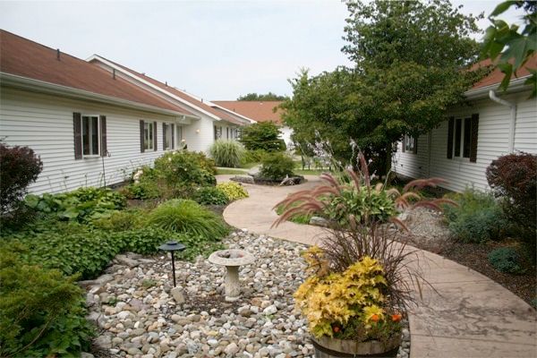 A beautifully landscaped garden with a winding pathway in a residential area.