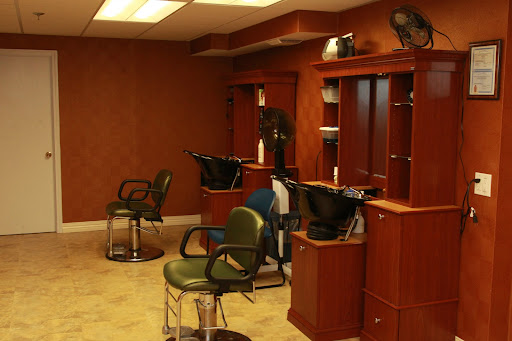 An interior view of a modern hair salon featuring barber chairs and wooden decor.