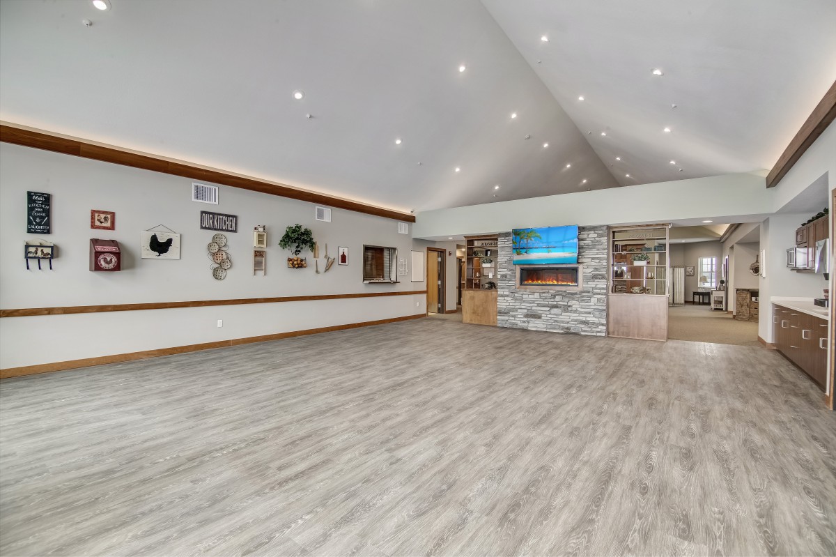 A modern reception area with wood flooring, decorative walls, and ceiling lights.