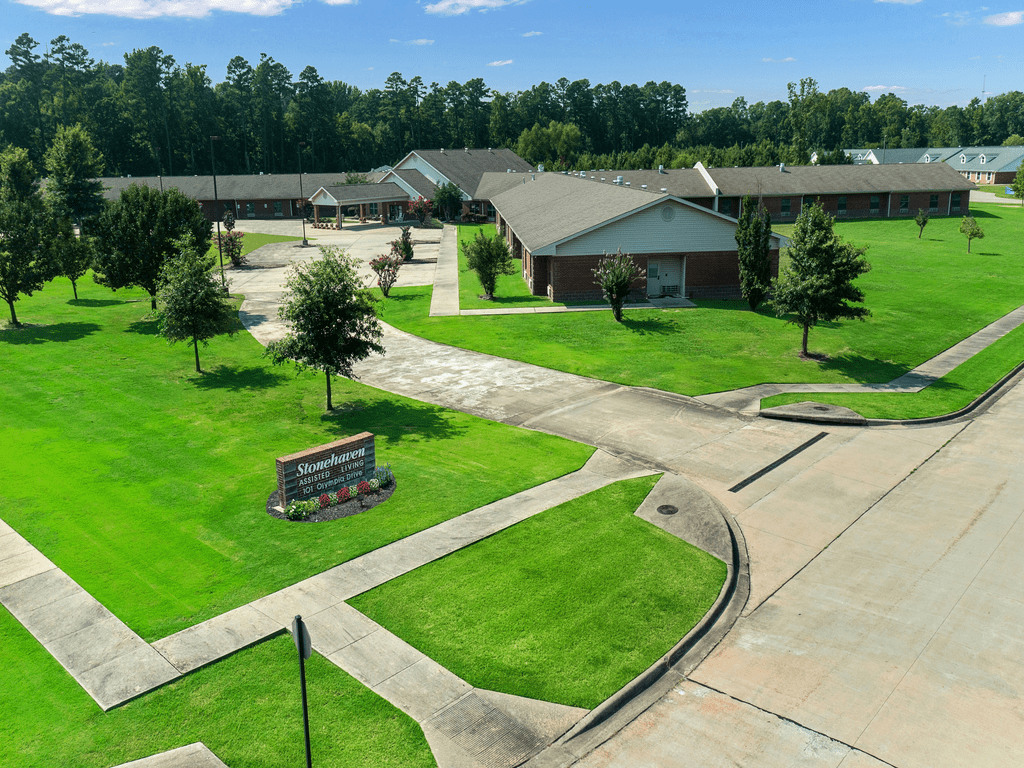 Aerial view of a school campus with green lawns and multiple buildings.