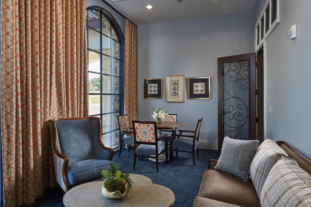 A elegantly designed living room with a seating area and dining table.