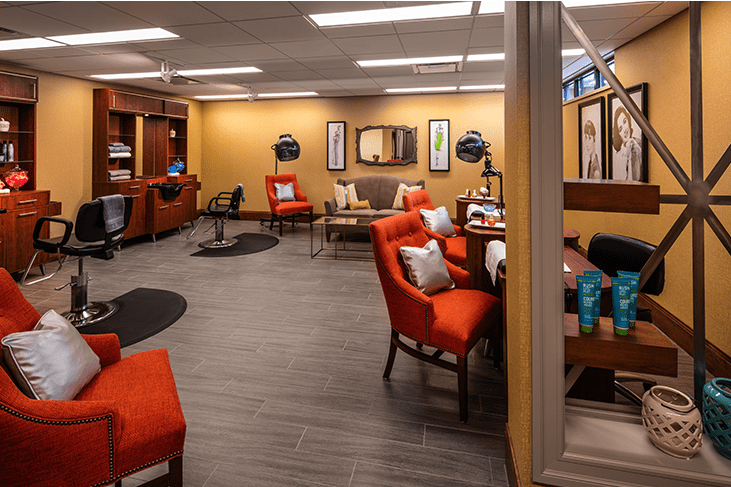 A modern office waiting area with comfortable seating and a warm color palette.