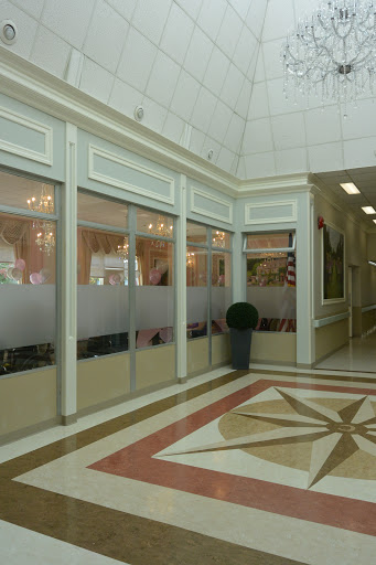 A spacious lobby with elegant architectural details and glass partitions.