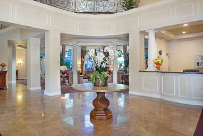 A luxurious foyer with a central floral arrangement and elegant interior design.