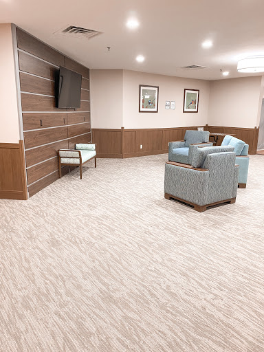 A modern lounge area featuring comfortable seating and a television.