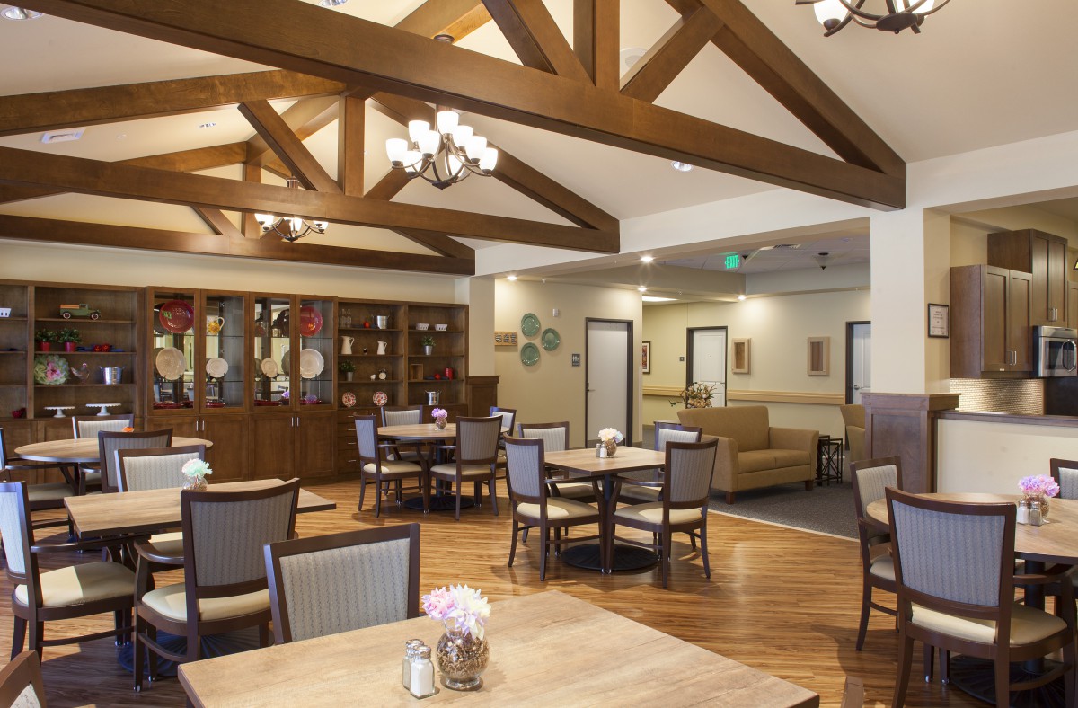 A cozy dining area with wooden beams and elegant lighting.