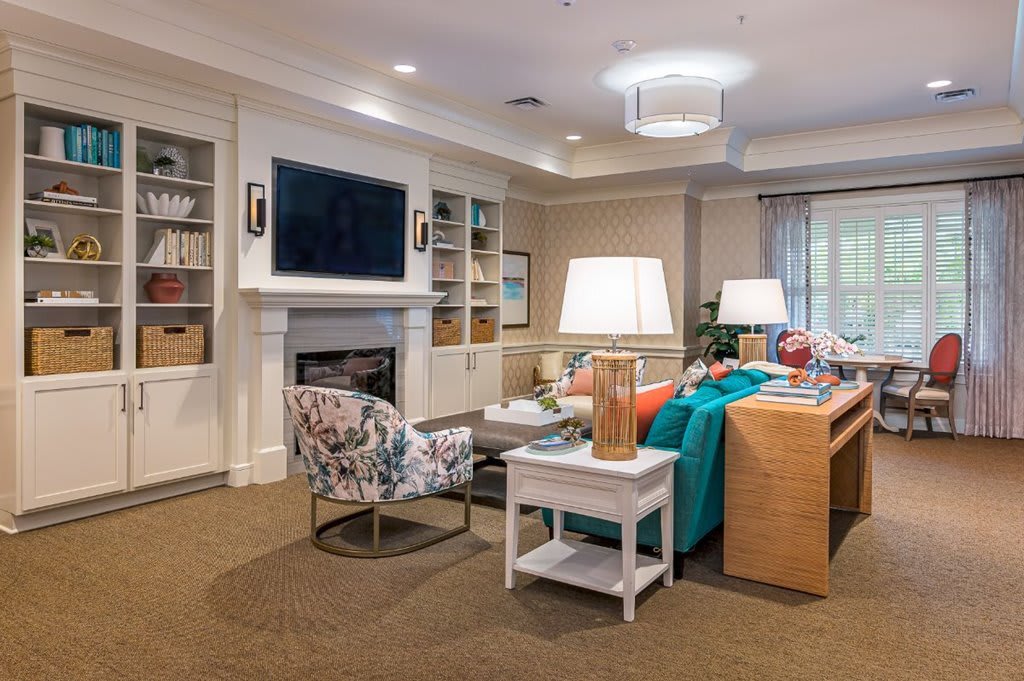 A cozy and well-designed living room with a fireplace, TV, and comfortable seating.