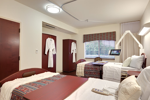A well-furnished hotel room featuring two beds, stylish decor, and comfortable amenities.