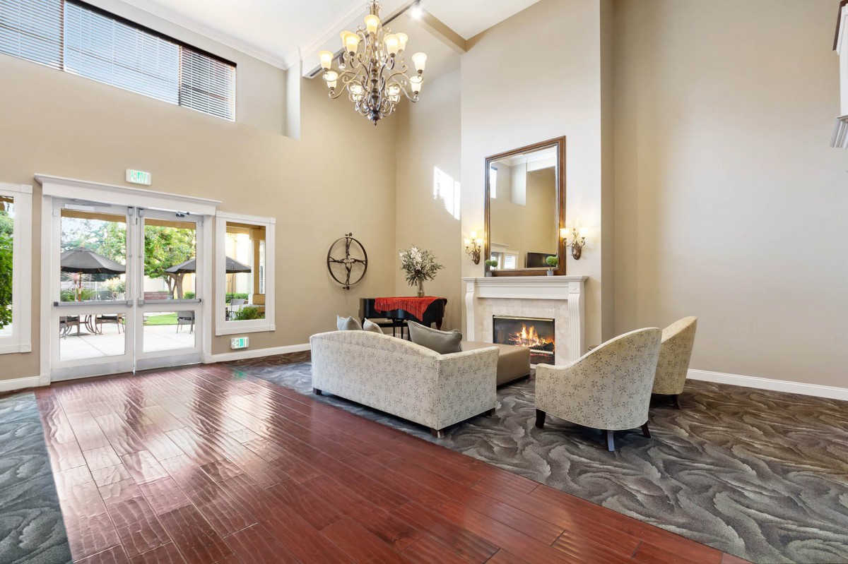 A modern lobby with elegant seating and a fireplace.