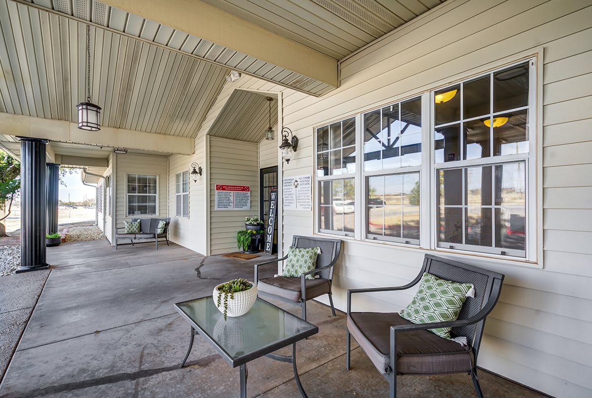 A cozy outdoor patio area with comfortable seating and decorative plants.