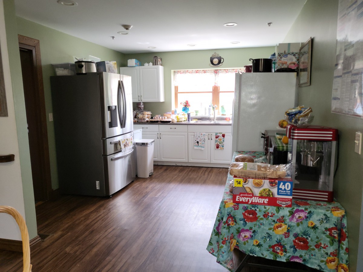 A spacious kitchen with modern appliances and a decorated table.