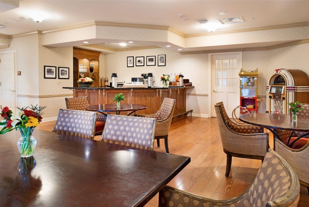 Cozy hotel lobby with a coffee station and seating area.