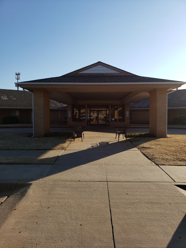 A welcoming entrance of a building, bathed in warm sunlight.