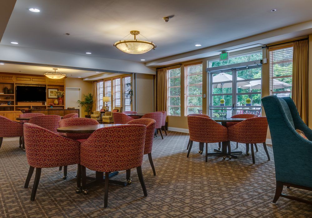 A cozy lounge with comfortable seating and large windows.
