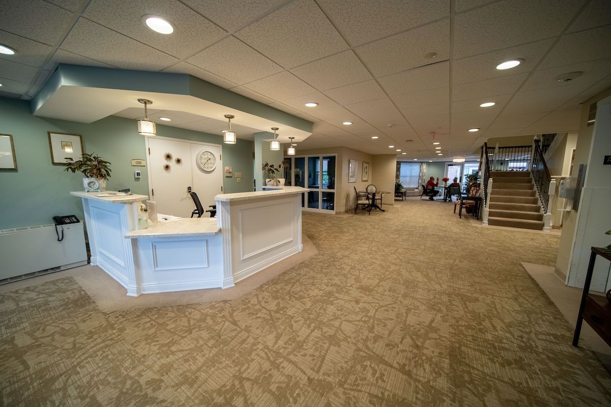 A modern and spacious reception area with a desk and seating.