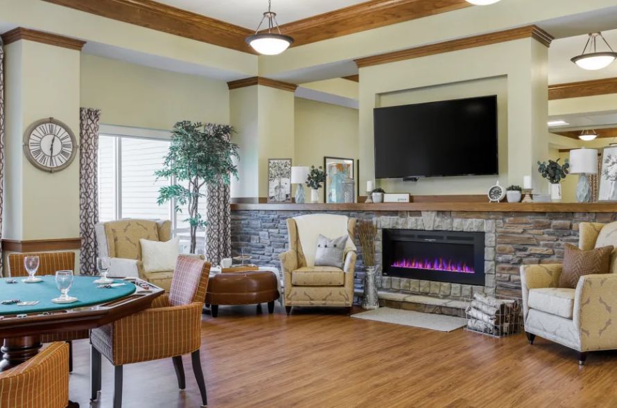 A cozy living room with a fireplace, television, and comfortable seating.