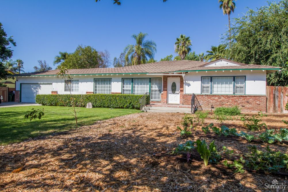 A suburban house with a well-maintained front yard and garden.