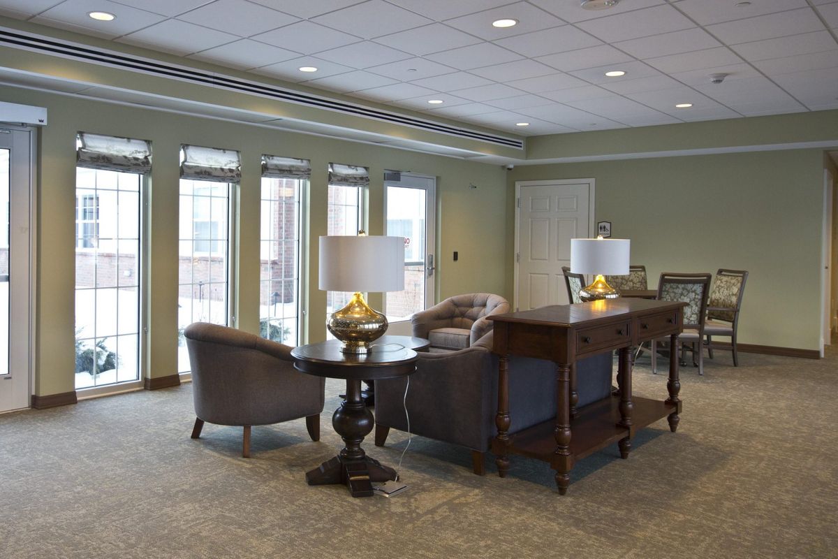 A well-lit lobby area with comfortable seating and decorative lamps.