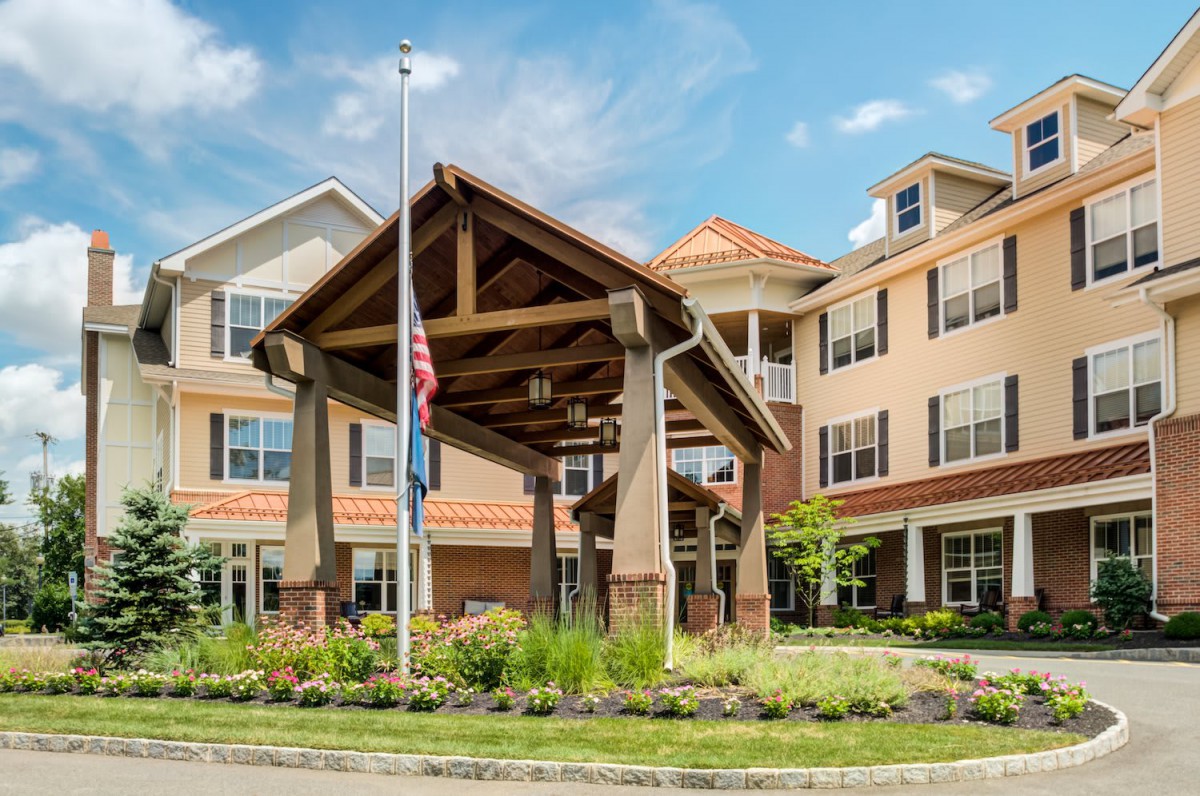 Exterior view of a residential building with landscaped entrance.