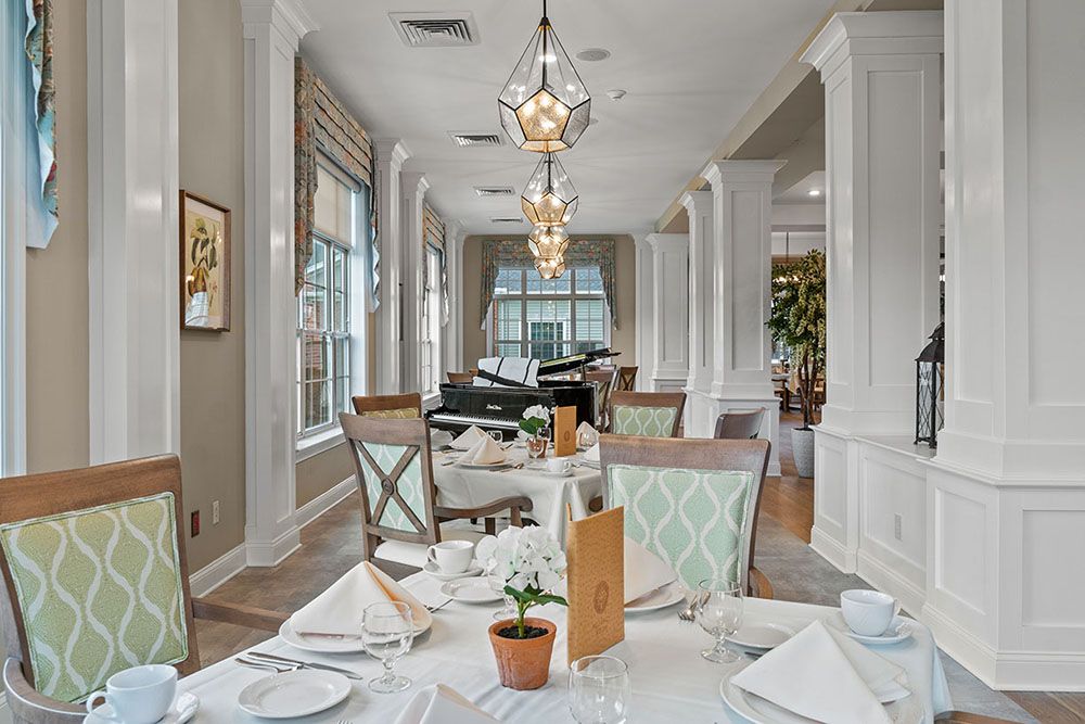 An elegant restaurant dining room featuring neatly set tables, ambient lighting, and stylish decor.