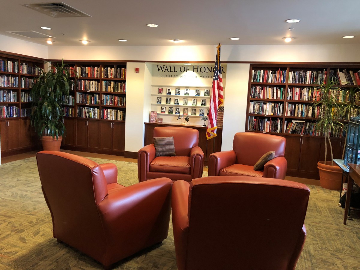 A cozy library reading area with comfortable chairs and bookshelves.