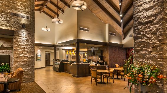 A cozy restaurant interior with modern design elements and wooden beams.