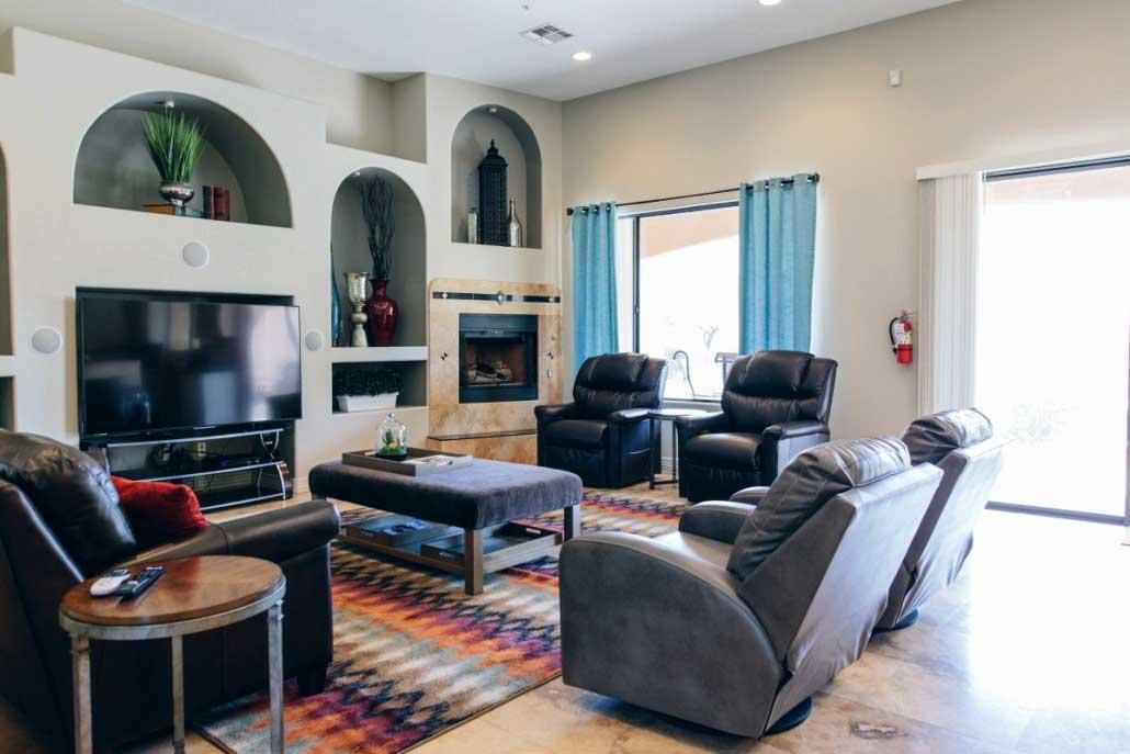A cozy living room with modern decor, featuring comfortable seating and a fireplace.