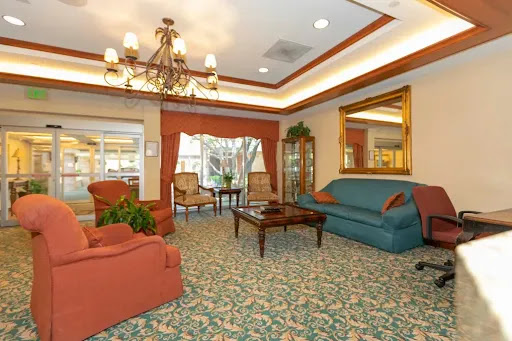 A cozy living room setting featuring comfortable seating and warm lighting.