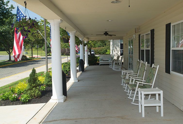 A charming porch with rocking chairs and classic columns, perfect for relaxation.