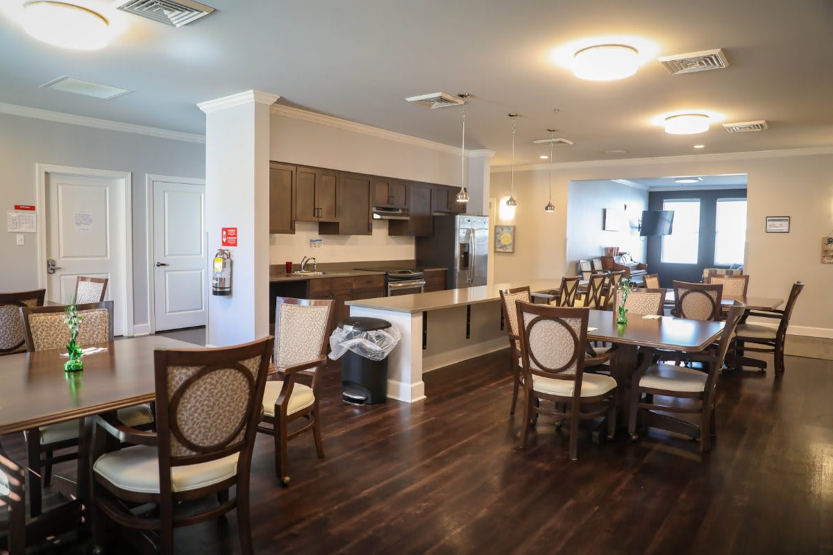 Modern kitchen and dining area with wooden flooring and stylish furnishings.