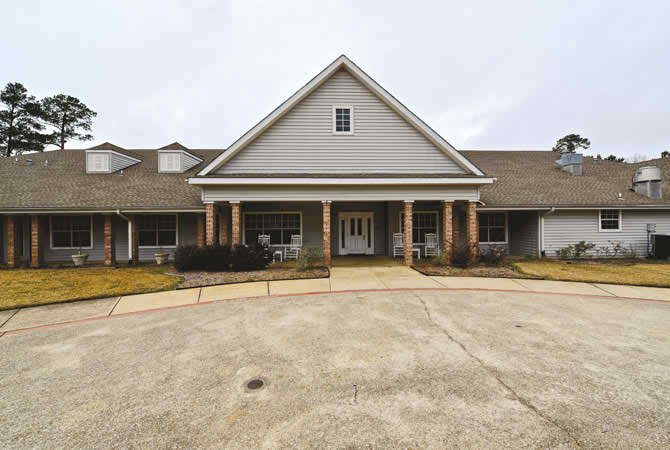 A front view of a residential building with a driveway.