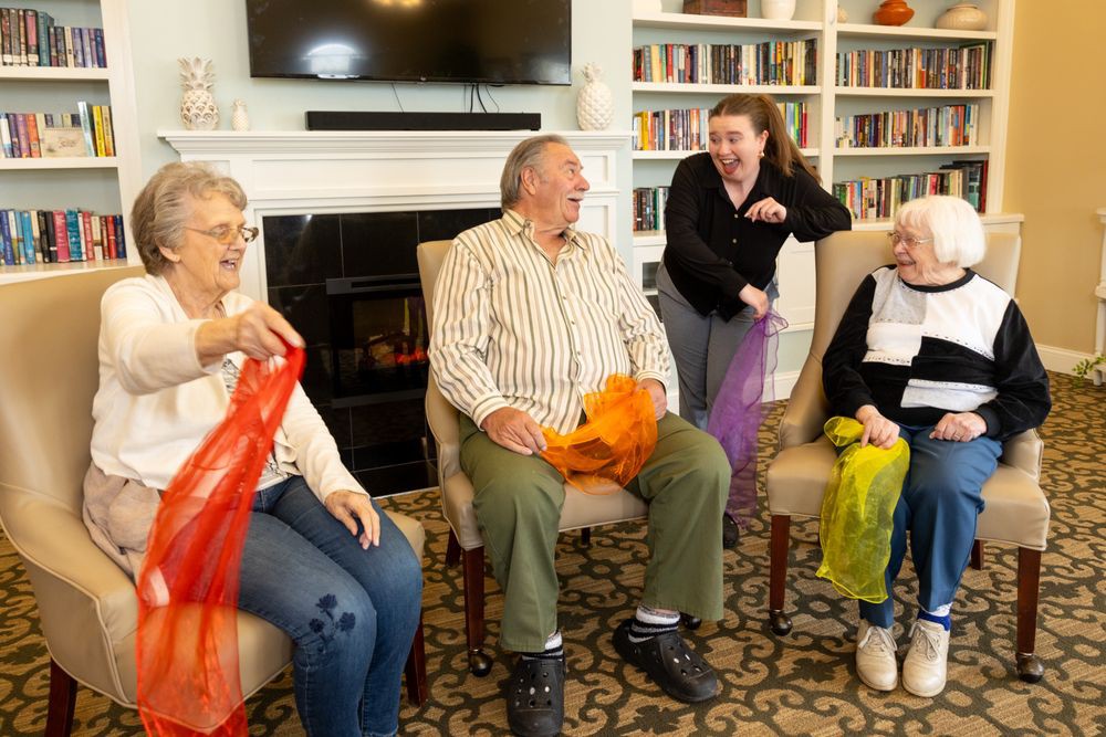 A group of elderly individuals enjoying a lively activity together indoors.