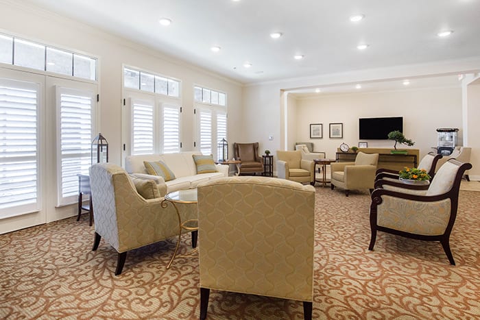 A well-lit modern living room with comfortable seating and elegant decor.