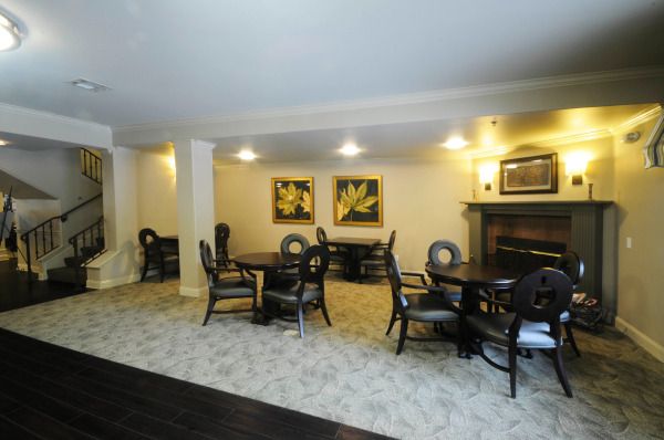 A cozy, elegantly furnished living area with multiple seating arrangements and a fireplace.