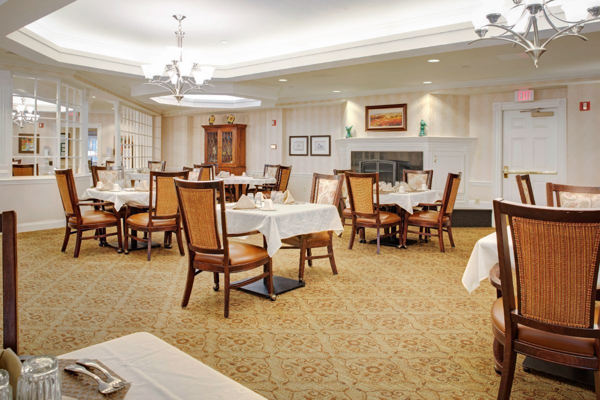 An elegant dining room with neatly arranged tables and chairs.