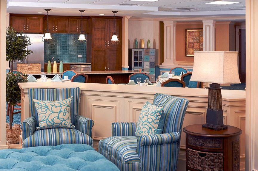 A cozy living room with blue upholstered furniture and elegant decor.