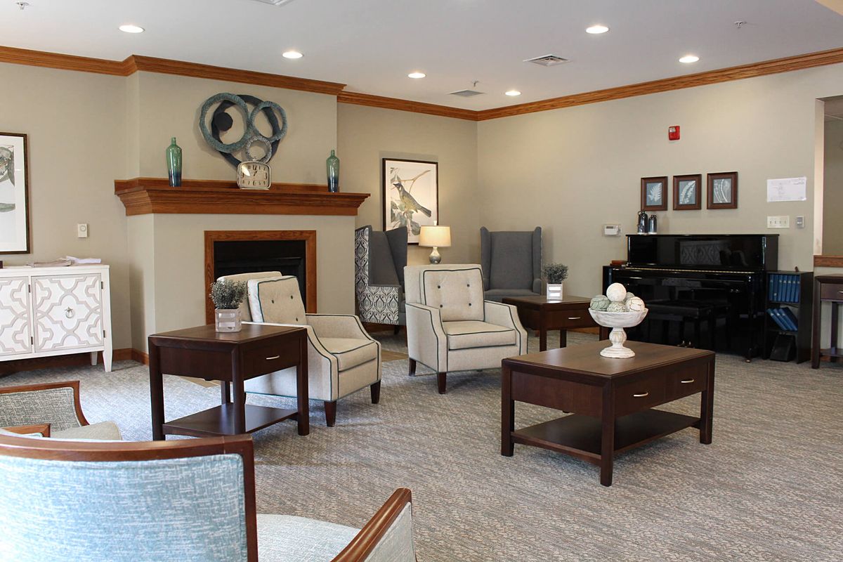 A cozy living room with elegant furniture and a fireplace, creating a warm and inviting atmosphere.