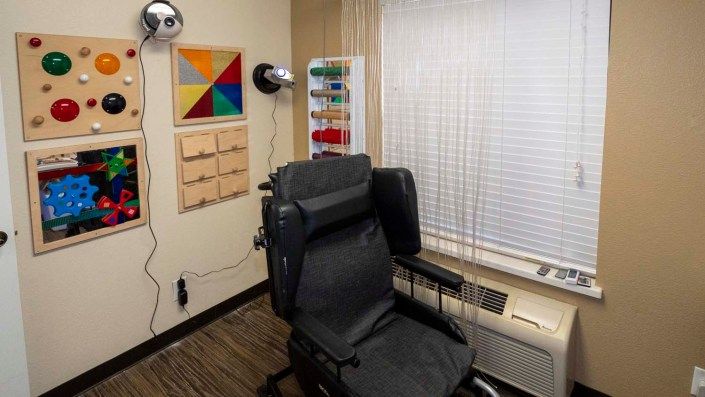 An eye examination room equipped with a chair and eye care tools.
