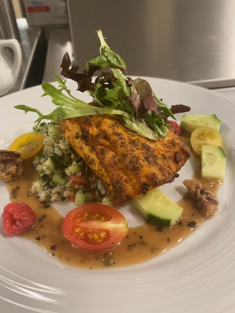 A beautifully presented vegetable dish with fresh greens and toppings.