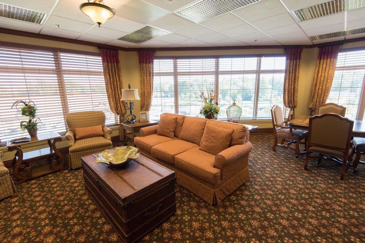 Spacious living room with cozy furniture and large windows.