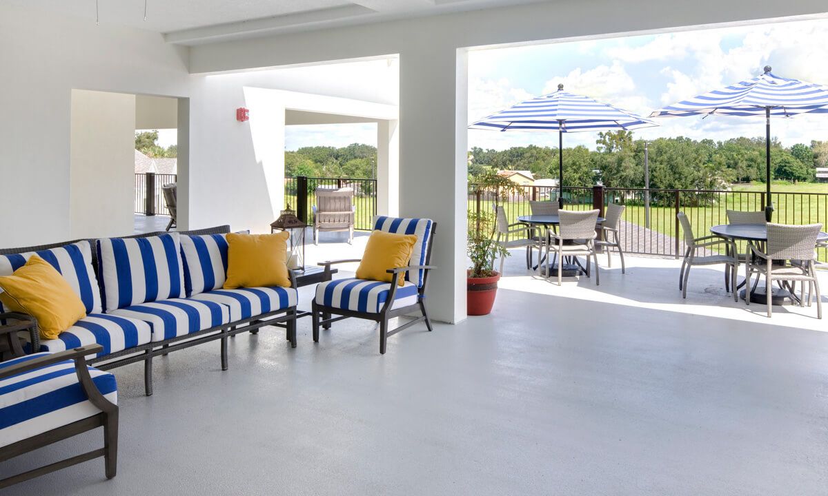 An inviting patio area with striped cushioned chairs and a scenic outdoor view.