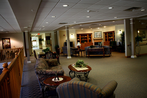A cozy lobby area featuring comfortable seating, bookshelves, and a welcoming atmosphere.