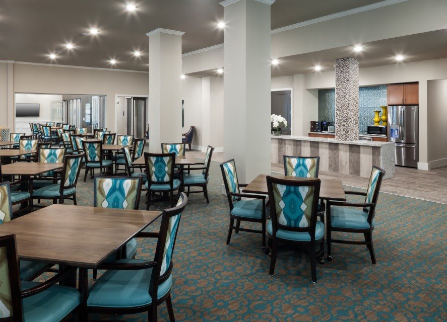 A spacious and modern dining area with neatly arranged tables and chairs.