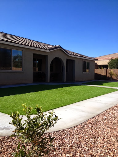 A beautiful residential property showcasing a well-maintained lawn and modern architecture.