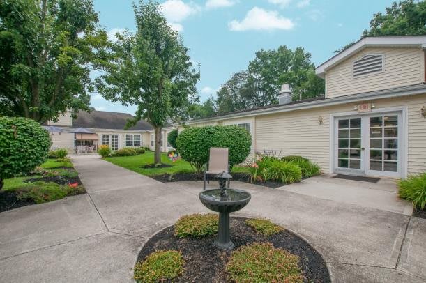 A serene courtyard with a central fountain and well-maintained landscaping.