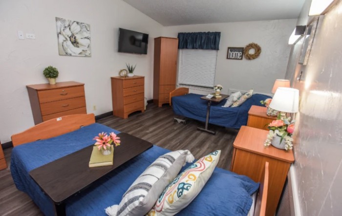 A cozy bedroom with two beds, wooden furniture, and modern decor.