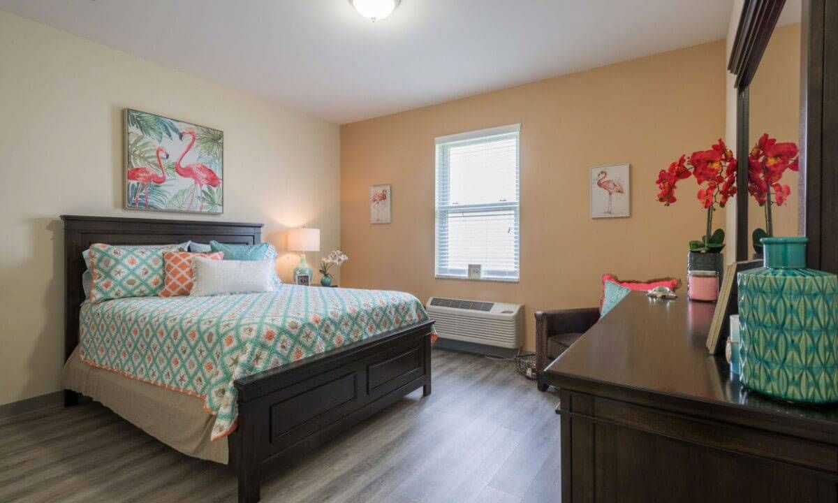 A cozy bedroom with a bed, window, and stylish decor.