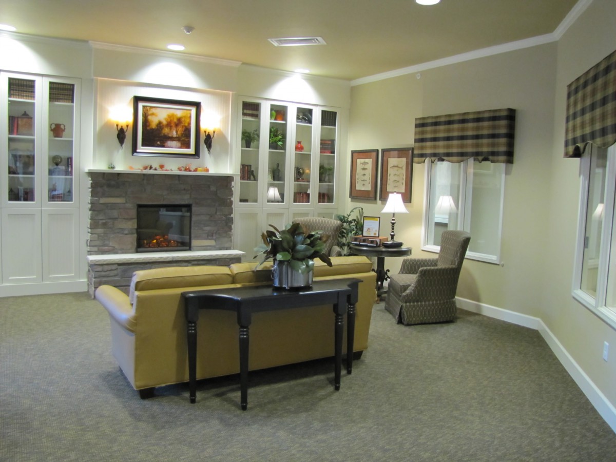 A cozy living room with a fireplace, sofa, and tasteful decor.