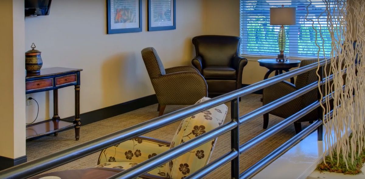 A cozy seating area with comfortable armchairs in a modern waiting room.